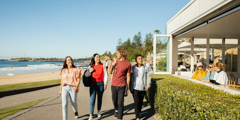 Group walking past Wollongong Diggies cafe