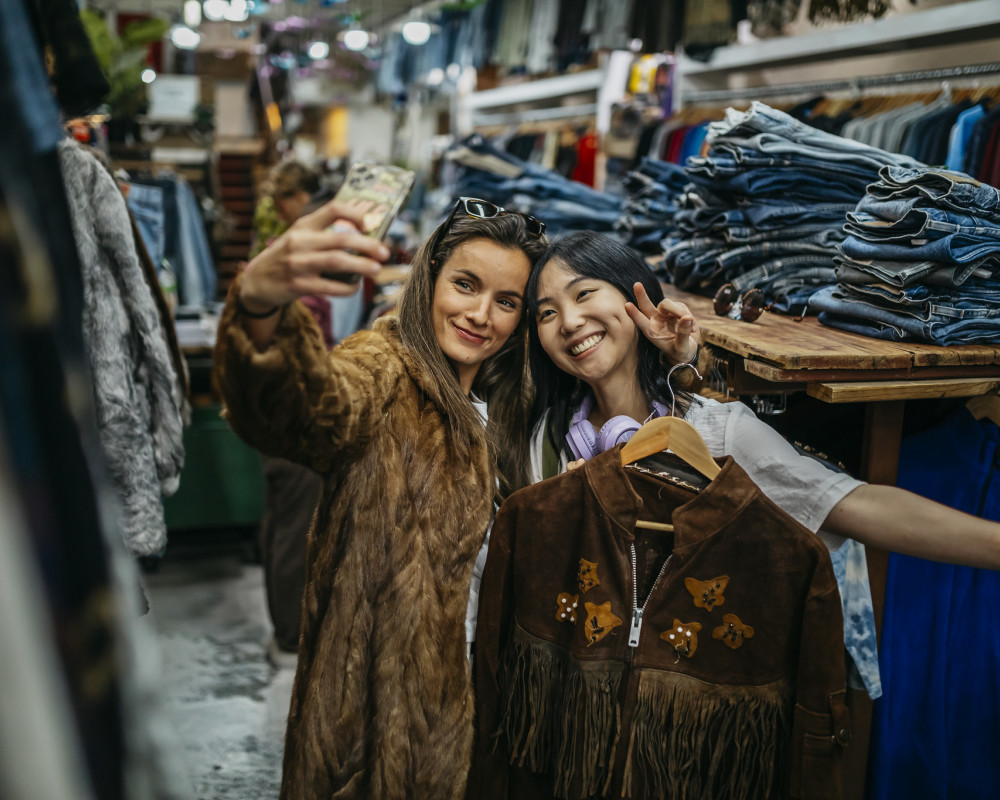 friends enjoying shopping and taking selfie