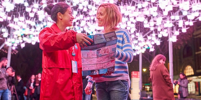 two volunteers looking at map at Vivid Sydney