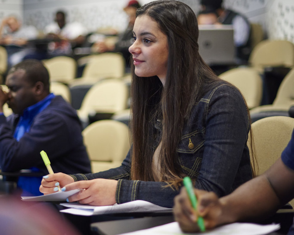 student taking an interest and taking notes in lecture at university in NSW